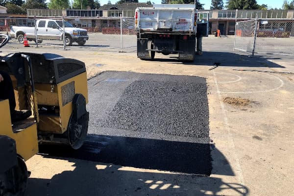 Pot hole being repaired in a parking lot