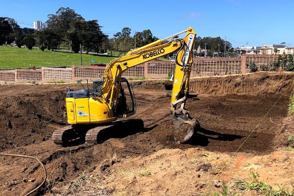 excavator working on new building site in San Jose