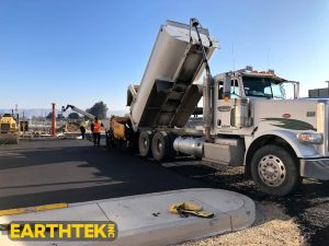 asphalt being delivered to parking lot paving project