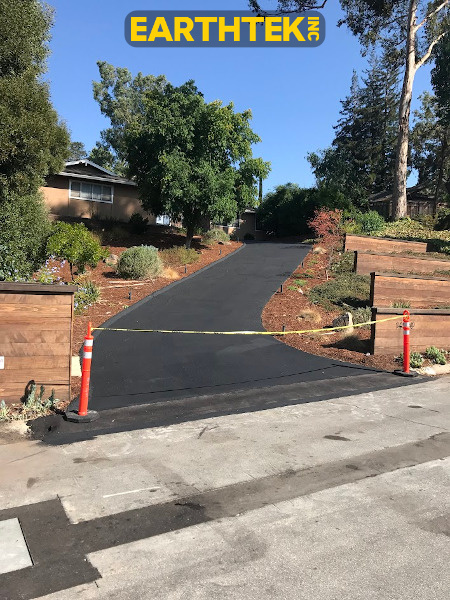 long driveway with workers sealcoating it