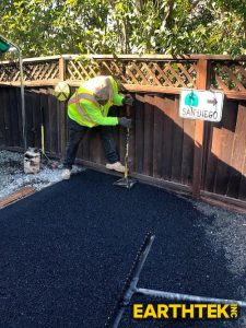 asphalt being installed on a driveway by crew