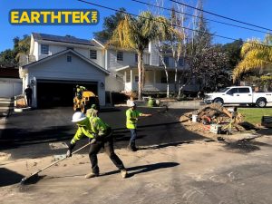 crew installing asphalt on residential driveway