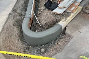 concrete parking curb being installed