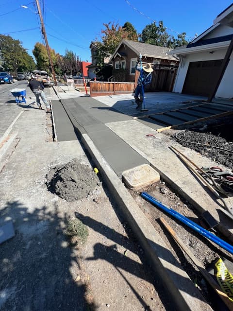 concrete apron and a gutter being installed